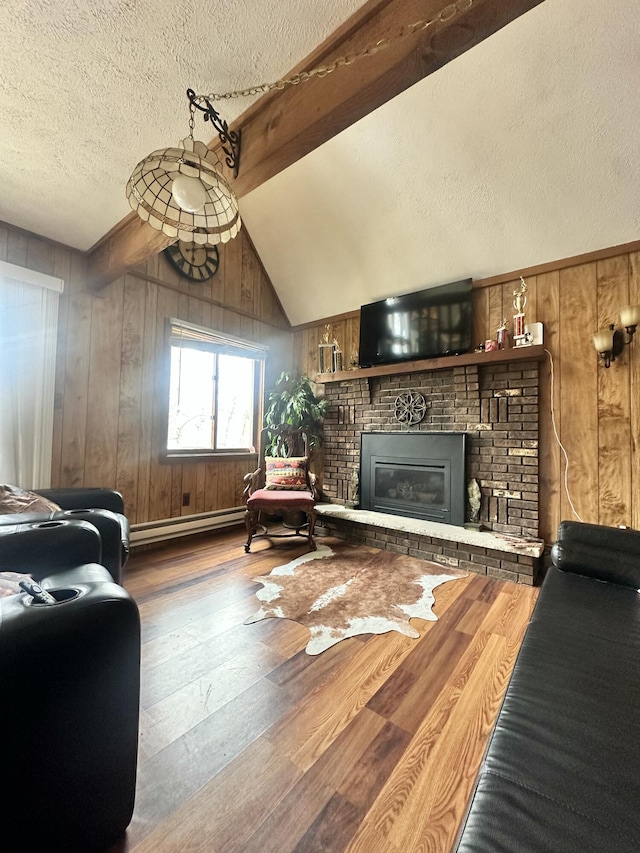living room featuring wooden walls, wood finished floors, and a fireplace