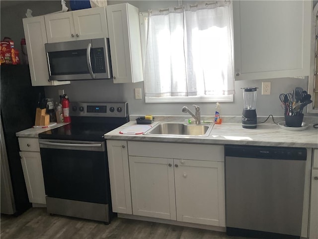 106 Lakota Rd, East Stroudsburg, PA 18302 - kitchen with appliances with stainless steel finishes, a sink, white cabinetry, and light countertops