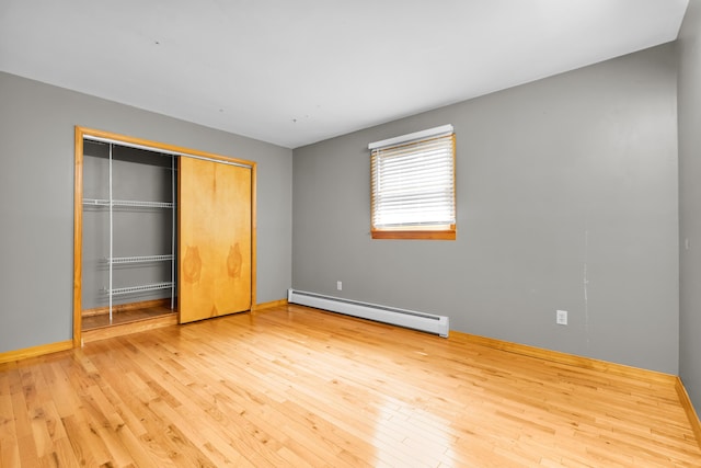 4620 Buck Valley Cir E, Stroudsburg, PA 18301 - unfurnished bedroom featuring a baseboard radiator, hardwood / wood-style floors, and a closet