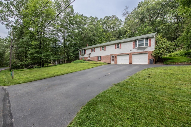 4620 Buck Valley Cir E, Stroudsburg, PA 18301 - bi-level home with asphalt driveway, an attached garage, brick siding, and a front lawn