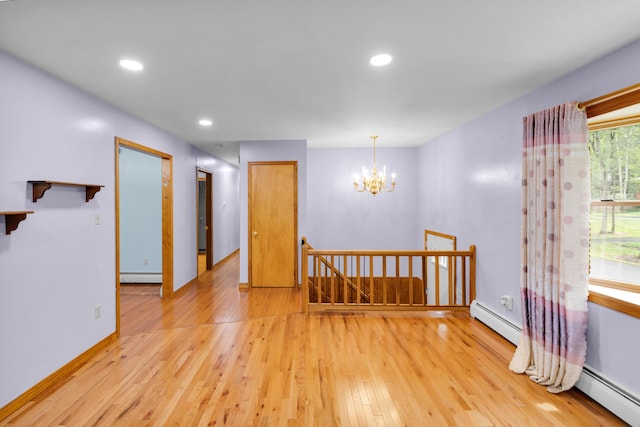 4620 Buck Valley Cir E, Stroudsburg, PA 18301 - spare room with a baseboard heating unit, light wood-style floors, a chandelier, and recessed lighting