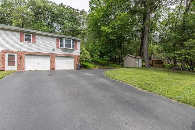 4620 Buck Valley Cir E, Stroudsburg, PA 18301 - view of front facade featuring driveway, brick siding, an attached garage, and view of scattered trees