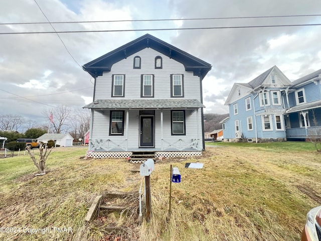 view of front of house with a porch and a front yard