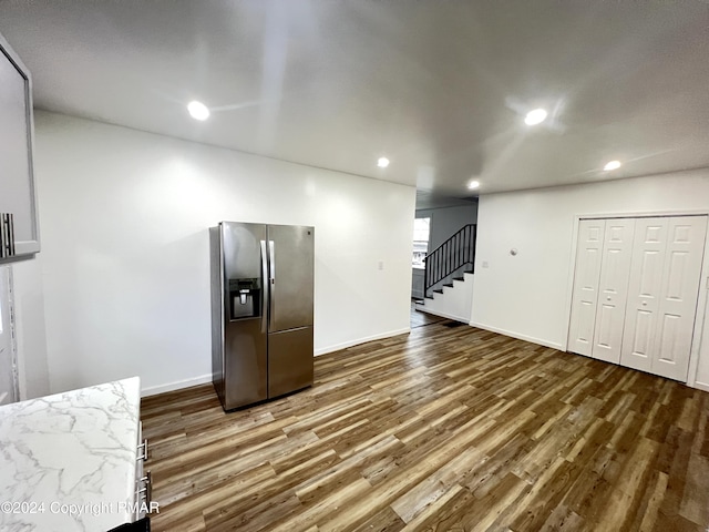 kitchen with recessed lighting, stainless steel fridge, baseboards, and wood finished floors