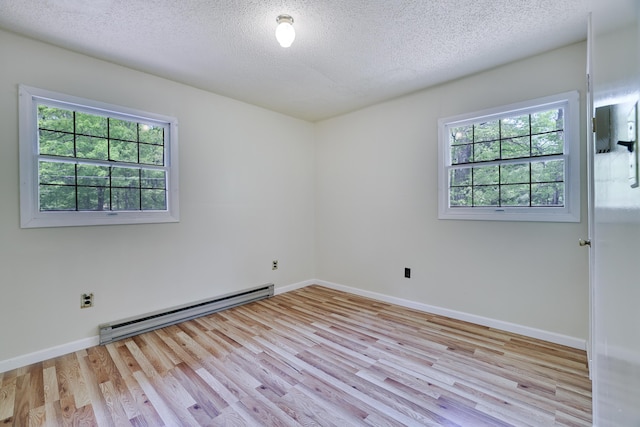 289 Towamensing Trl, Albrightsville, PA 18210 - unfurnished room with a baseboard radiator, plenty of natural light, light wood-style floors, a textured ceiling, and baseboards