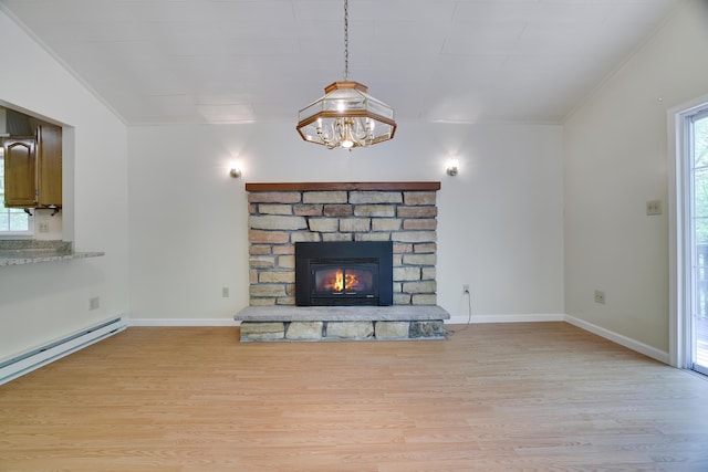 289 Towamensing Trl, Albrightsville, PA 18210 - unfurnished living room featuring light wood finished floors, a baseboard heating unit, ornamental molding, a stone fireplace, and baseboards