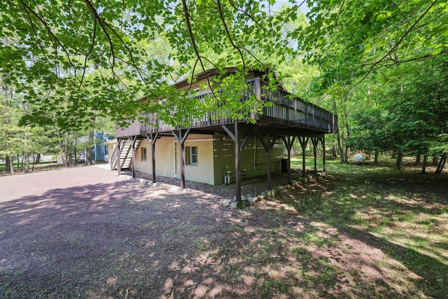 289 Towamensing Trl, Albrightsville, PA 18210 - view of property exterior featuring stairway, a deck, gravel driveway, and stucco siding