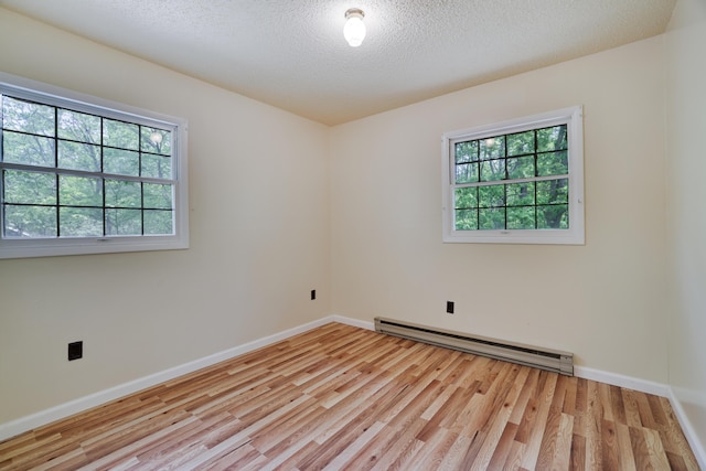 289 Towamensing Trl, Albrightsville, PA 18210 - spare room featuring a baseboard radiator, wood finished floors, a textured ceiling, and baseboards