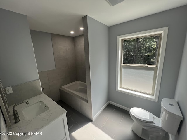 full bathroom with a bathtub, toilet, vanity, tile patterned flooring, and baseboards