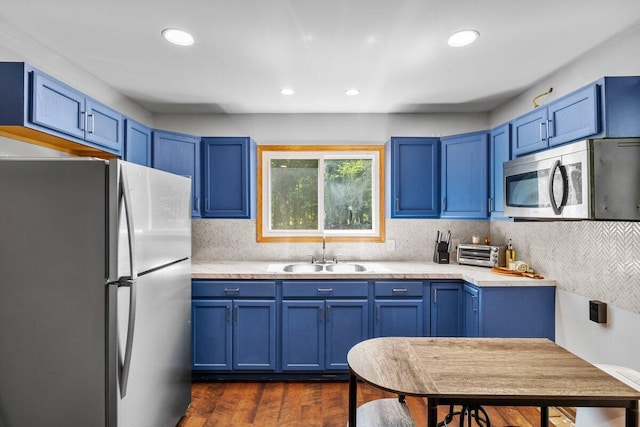 322 Clubhouse Dr, East Stroudsburg, PA 18302 - kitchen featuring freestanding refrigerator, a sink, stainless steel microwave, blue cabinets, and recessed lighting