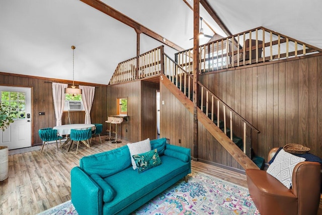 322 Clubhouse Dr, East Stroudsburg, PA 18302 - living area with plenty of natural light, wood walls, high vaulted ceiling, wood finished floors, and stairway