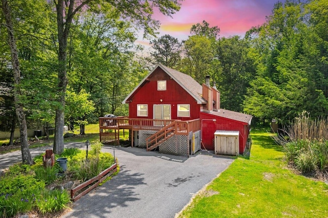 322 Clubhouse Dr, East Stroudsburg, PA 18302 - chalet / cabin with a chimney, stairway, a wooden deck, and a lawn