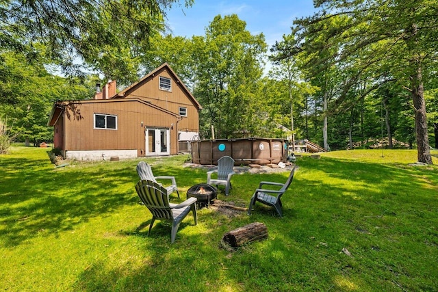 322 Clubhouse Dr, East Stroudsburg, PA 18302 - rear view of property featuring french doors, an outdoor fire pit, a yard, and an outdoor pool