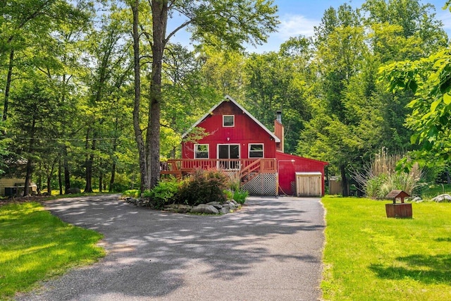 322 Clubhouse Dr, East Stroudsburg, PA 18302 - rustic home featuring asphalt driveway, a chimney, a garage, and a front yard