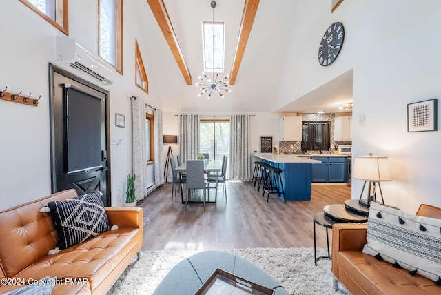 living room featuring beam ceiling, an inviting chandelier, high vaulted ceiling, and light wood-style floors