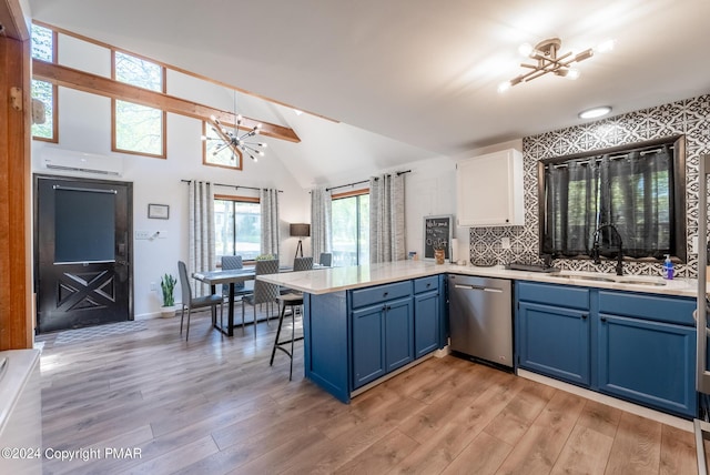 kitchen with an inviting chandelier, a peninsula, a sink, stainless steel dishwasher, and blue cabinets