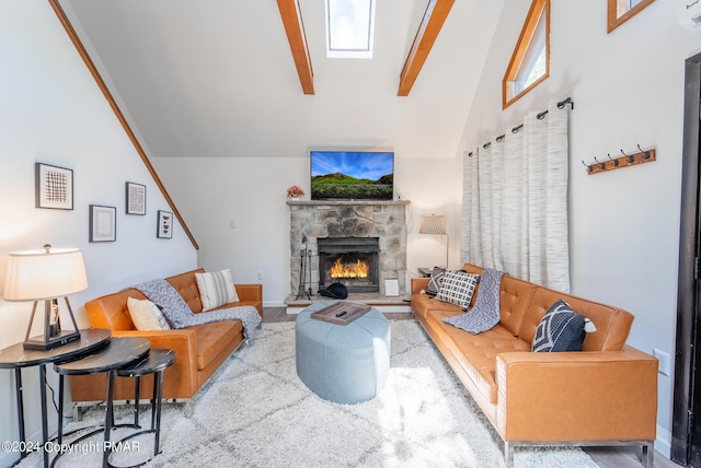 living room with vaulted ceiling with skylight, a fireplace, and baseboards