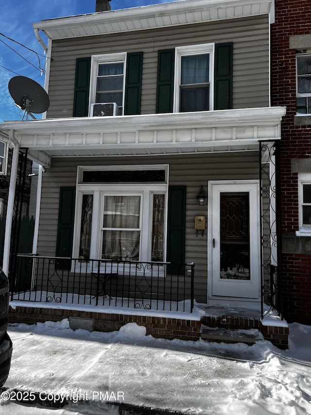 view of snow covered property entrance