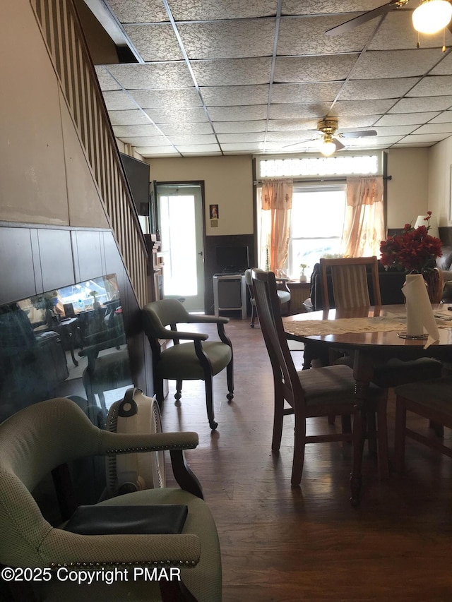 dining room with hardwood / wood-style flooring and a paneled ceiling