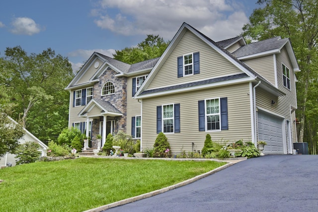 603 Washington Xing, East Stroudsburg, PA 18301 - traditional-style home with asphalt driveway, an attached garage, a front lawn, and roof with shingles