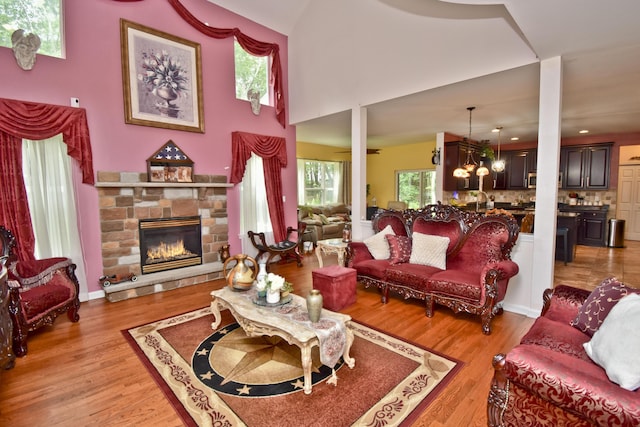 603 Washington Xing, East Stroudsburg, PA 18301 - living area with a chandelier, a stone fireplace, and light wood-style flooring