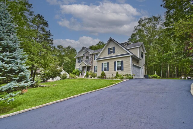 603 Washington Xing, East Stroudsburg, PA 18301 - traditional-style house with driveway, an attached garage, and a front yard