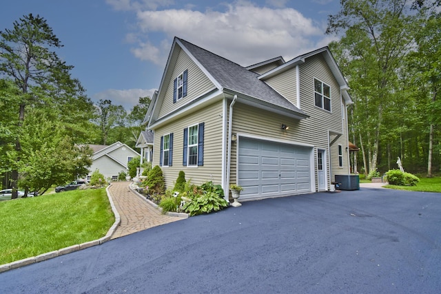 603 Washington Xing, East Stroudsburg, PA 18301 - view of home's exterior featuring driveway, a shingled roof, and a yard