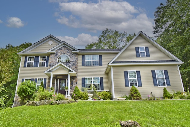 603 Washington Xing, East Stroudsburg, PA 18301 - view of front facade with a front yard and stone siding