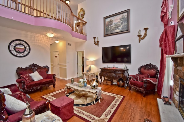 603 Washington Xing, East Stroudsburg, PA 18301 - living area featuring wood finished floors, a fireplace, and a high ceiling