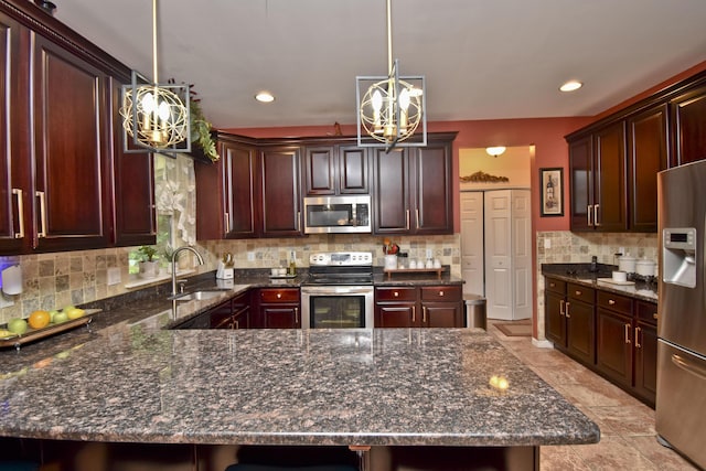 603 Washington Xing, East Stroudsburg, PA 18301 - kitchen with stainless steel appliances, a chandelier, tasteful backsplash, decorative light fixtures, and a peninsula