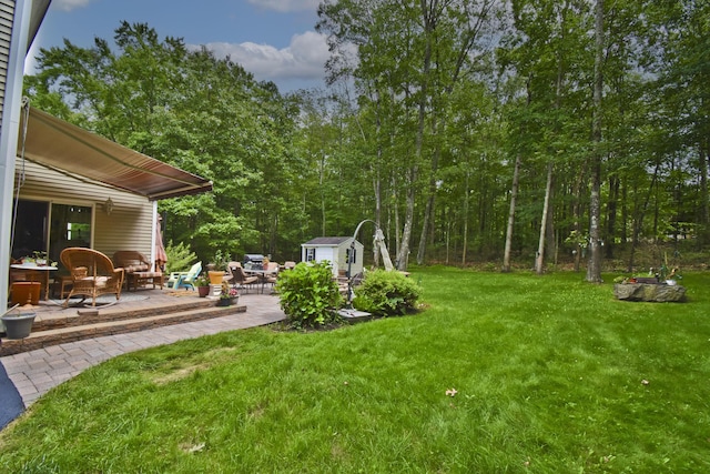 603 Washington Xing, East Stroudsburg, PA 18301 - view of grassy yard featuring a patio area and a storage shed