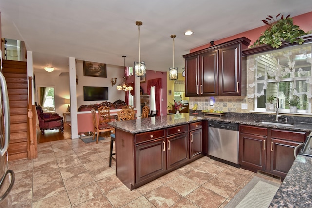 603 Washington Xing, East Stroudsburg, PA 18301 - kitchen featuring stainless steel dishwasher, a peninsula, decorative light fixtures, decorative backsplash, and dark stone countertops