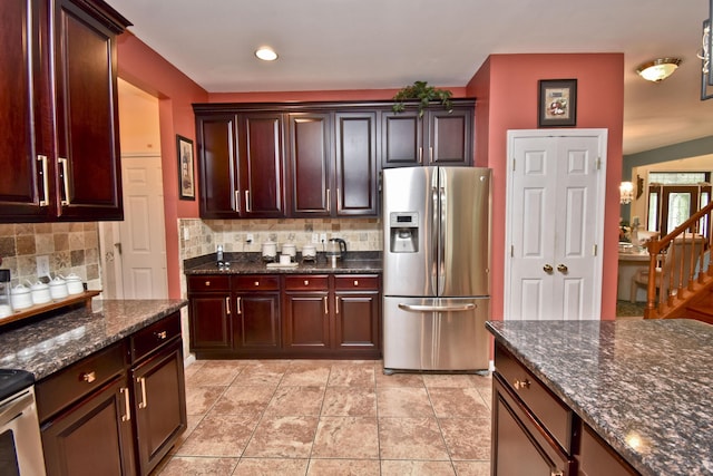 603 Washington Xing, East Stroudsburg, PA 18301 - kitchen featuring stainless steel fridge with ice dispenser, decorative backsplash, range, and dark stone countertops