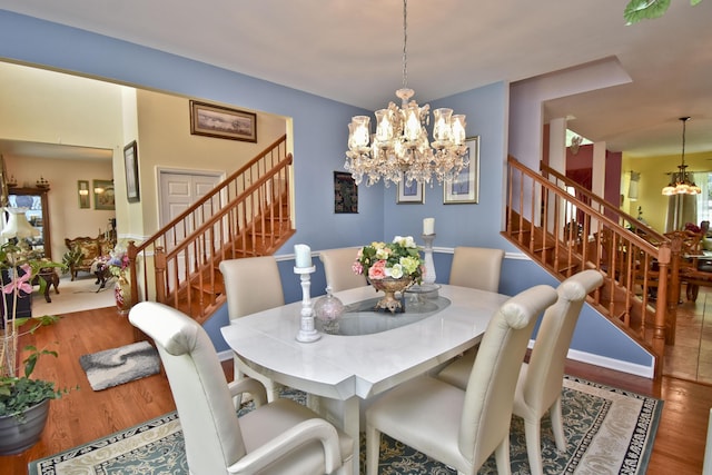 603 Washington Xing, East Stroudsburg, PA 18301 - dining area featuring a chandelier, stairway, and wood finished floors