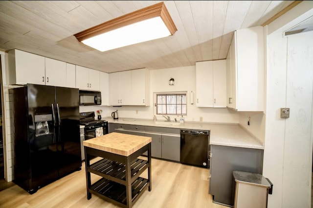 71 Dogwood Dr, Jim Thorpe, PA 18229 - kitchen featuring black appliances, wooden ceiling, light countertops, light wood-type flooring, and white cabinets