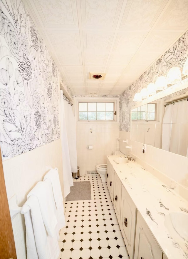 71 Dogwood Dr, Jim Thorpe, PA 18229 - bathroom featuring double vanity, wallpapered walls, a wainscoted wall, and a shower with curtain
