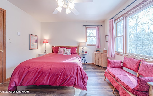 bedroom with ceiling fan and wood-type flooring