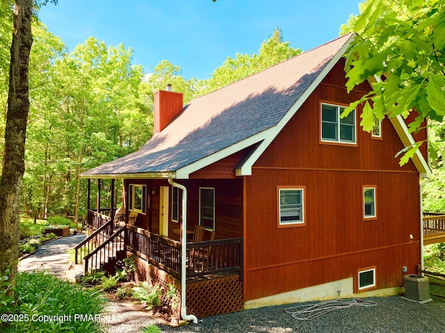 view of side of home with central air condition unit