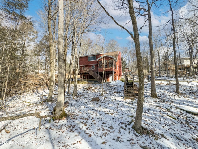 snow covered property featuring a deck