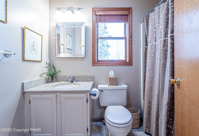 bathroom featuring vanity, walk in shower, tile patterned floors, and toilet