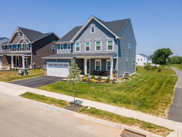 view of front of home featuring a porch, asphalt driveway, a front yard, and central AC unit