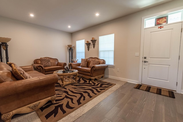living room with wood finished floors, recessed lighting, and baseboards