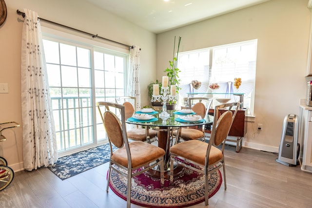 dining space featuring wood finished floors and baseboards