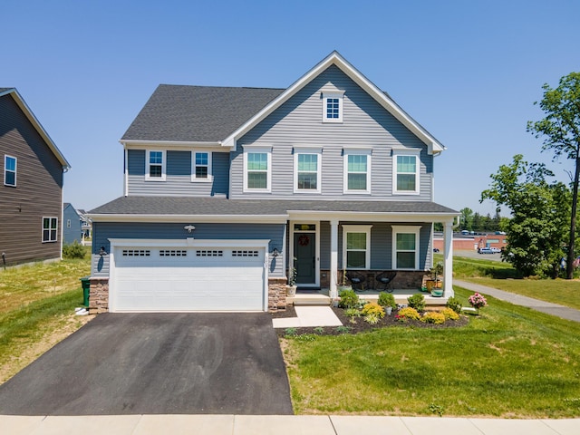 view of front of home with covered porch, asphalt driveway, stone siding, and an attached garage
