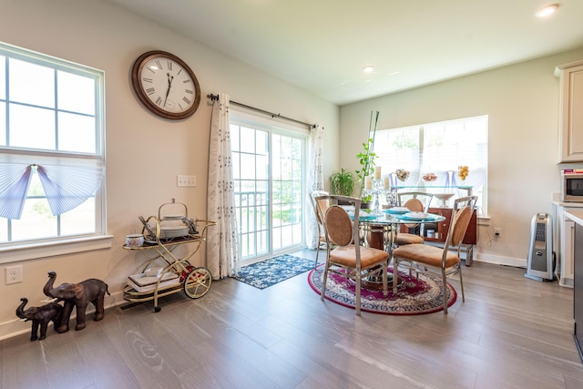 dining space with wood finished floors, recessed lighting, and baseboards