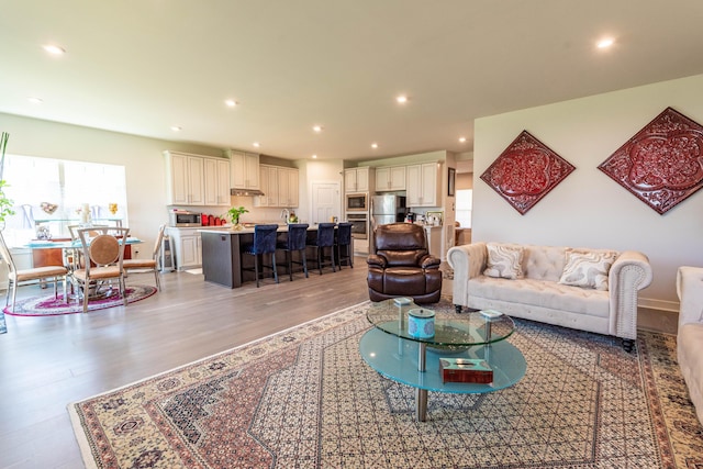 living room featuring light wood-style flooring and recessed lighting