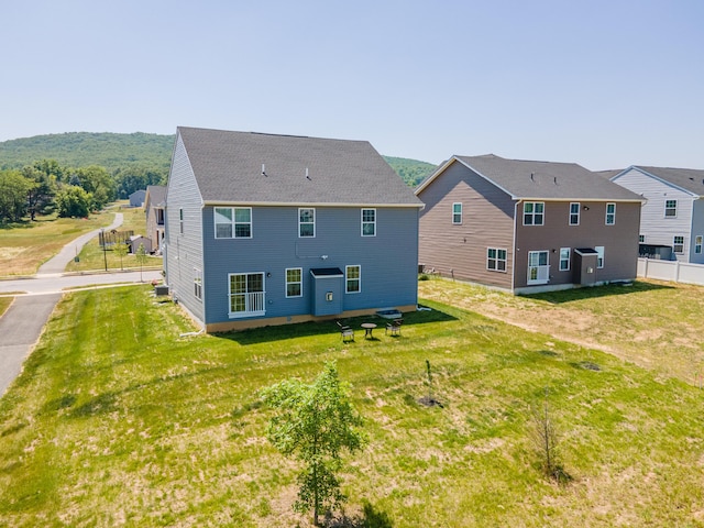 back of property with a yard