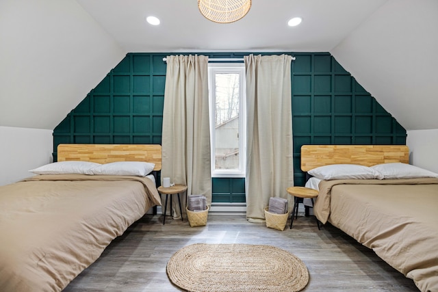 130 Sweet Briar Rd, Pocono Pines, PA 18350 - bedroom featuring vaulted ceiling, a decorative wall, wood finished floors, an accent wall, and recessed lighting