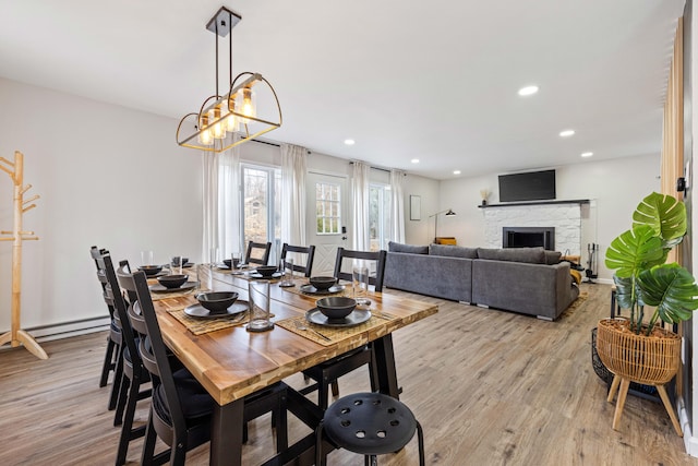 130 Sweet Briar Rd, Pocono Pines, PA 18350 - dining area with light wood finished floors, recessed lighting, a baseboard heating unit, a stone fireplace, and a chandelier