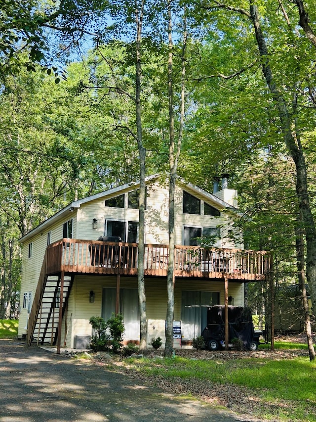 54 Spencer Ln, Albrightsville, PA 18210 - rear view of house with a deck, stairway, and a chimney